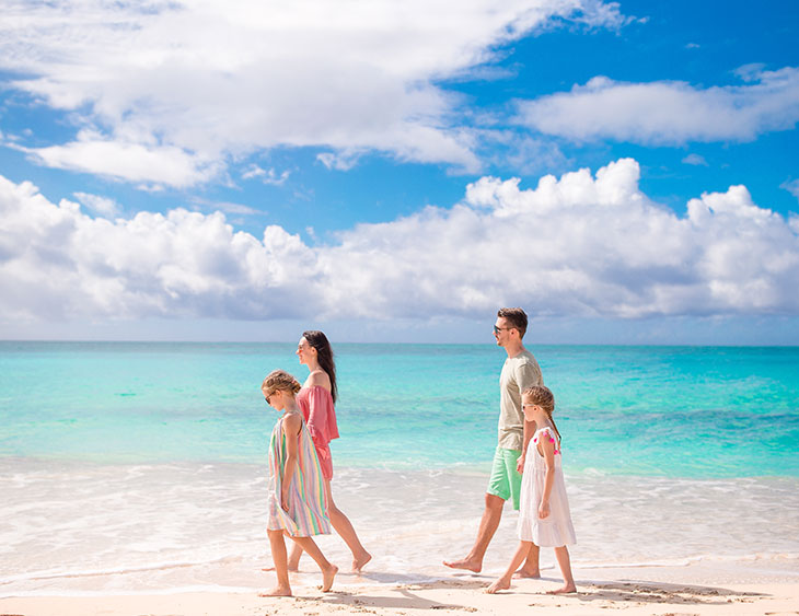 Envy-Boutique-Travel-Blog-Family-Walking-Beach-Travelling